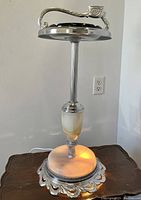 Full front view of the illuminated ashtray stand showing base lit and overall height