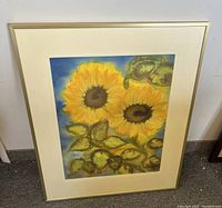 Front view of framed sunflower painting showing overall condition and colors.