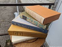 Five hardcover classic literature books stacked vertically with slipcase box on top. Titles visible on book spines and case.