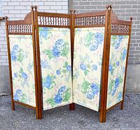 View of the full four-panel folding partition displaying entire floral fabric and wood spindle frames.