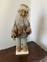 Front view of vintage mechanical gnome figurine showing full figure standing on base.