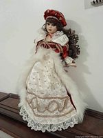 Full front view of the porcelain collectible doll showing detailed Victorian-style dress and accessories.