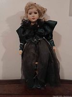 Front view of the porcelain doll showing face and dress details.
