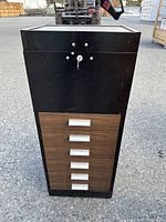 Front view of the lockable metal drawer cabinet showing six wooden front drawers with metal handles and lock with key at top.