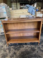 Front view of wooden two-shelf unit showing measurements and shelf structure