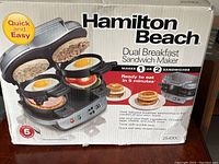 Box view of Hamilton Beach Dual Breakfast Sandwich Maker with product photo and features
