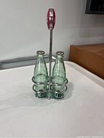 Front view of Coca Cola salt and pepper shakers in metal holder