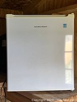 Front view of the Hamilton Beach mini fridge showing the white exterior and brand logo.