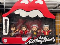 Front view of the Rolling Stones Little People figures in original packaging featuring red lips logo and clear display window.