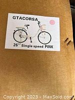 Packaging label showing GTACORSA brand, 26" single speed pink bicycle illustration.