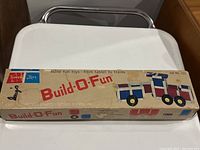 Original box of Build-O-Fun Set No. 101 with label and an image of a train constructed from the parts