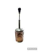 Full view of the vintage food chopper showing glass jar, metal lid, and black knob handle attached to metal rod.