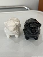 Front view of the white and black ceramic sheep-shaped salt and pepper shakers