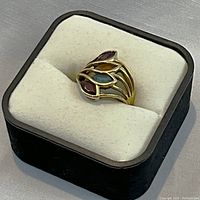 Ring displayed in black jewelry box on foam insert, angled view of full piece