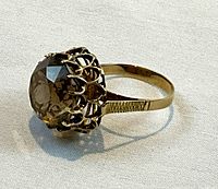 Side view showing open-work filigree basket and faceted smokey quartz gemstone