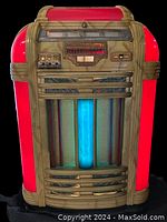 Front view showing illuminated blue central tube and red acrylic side panels