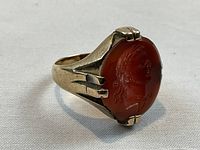Front-right angle showing oval carnelian intaglio with Roman profile and prong setting