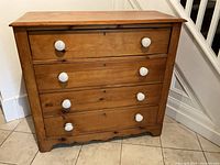 Front view of pine dresser showing four drawers and ceramic knob pulls