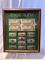Framed display with uncut block of 4 Canadian one dollar bills and historical smaller bill images below