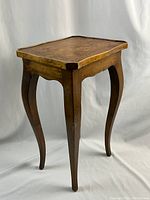Front three-quarter view of side table showing overall form, inlay top and leg design