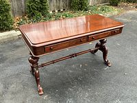 Full angle view of the rectangular mahogany top, drawers and pedestal base