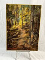 Full front view of painting on easel with white backdrop