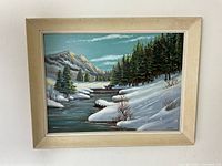 Frontal view of the framed winter river landscape painting