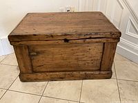 Front view of pine chest showing panel front and molded base