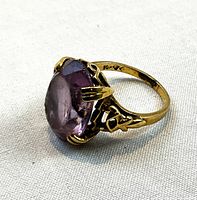 Front angle showing prong-set faceted amethyst and filigree shoulders