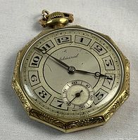 Front view of watch face showing silver-tone dial, black Arabic numerals, spade and whip hands, “Admiral” script and subsidiary seconds at six