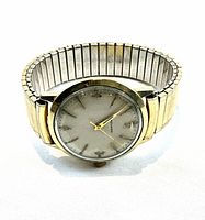 Front view showing round gold filled case, silver-tone patinated dial and gold tone hands.