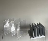Clear acrylic signage holders with base, arranged showing their structure and transparency