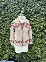 Front view of vintage Mary Maxim curling sweater, displaying knit pattern and fit on dress form.