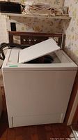 Front and top view of vintage Kenmore washing machine with lid open showing usage and condition.