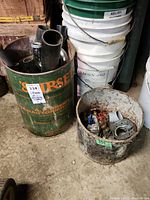 Two buckets with plumbing supplies including pipes, fittings, and connectors
