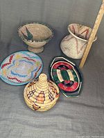 Photo showing all six items including vase, two bowls, lidded basket, and two platters with ruler for vase height reference