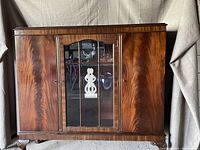 Front view of closed cabinet showing overall form and wood veneer finish