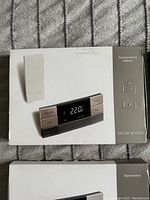 Original boxed Jacob Jensen Temperature Station and Barometer packaging showing modern minimalist design and branding.