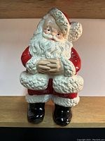 Full front view of the Santa Claus chalkware coin bank showing the detailed sculpting and paint on the figure.
