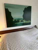 Frontal view of canvas print mounted above a king size bed