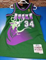 Front view of green Milwaukee Bucks basketball jersey with Ray Allen 34, Hardwood Classics patch and NBA patch.