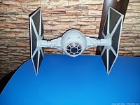 Full front view of the large Star Wars TIE Fighter showing the spherical cockpit and two solar panel wings.