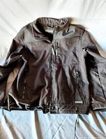 Full view of men's Dakota work jacket showing the front, black color, zippered pockets and stitching details.