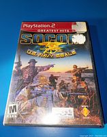 PlayStation 2 SOCOM U.S. Navy SEALs Greatest Hits game case front showing cover art with soldiers and game title.