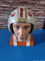 Front view of the Luke Skywalker Micro Machines head showing detailed pilot helmet and face sculpt.