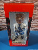 Front view of the Tie Domi Toronto Maple Leafs bobble head in original packaging showing hand-painted figure and box details.