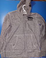 Full view of gray speckled Roots kids hoodie sweater, size Large (9-10 years), showing front with zipper, pockets, and hood.