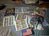 Several themed stamp sheets alongside a LIFE magazine and a patch, including Distinguished Soldiers and Distinguished Marines.