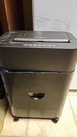Full view of black Royal AQ9100 paper shredder showing top controls and transparent bin window