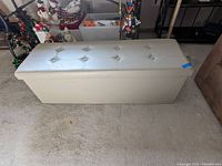 Vinyl upholstered storage bench seat with button tufted top, rectangular shape, light color